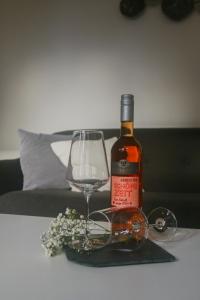 a bottle of wine and a glass on a table at Ferienhaus Bomeier in Wernigerode