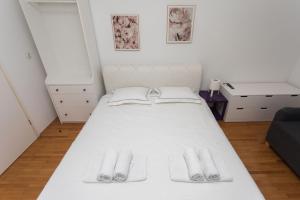 a bedroom with a white bed and a desk at BEUS DOWNTOWN in Split