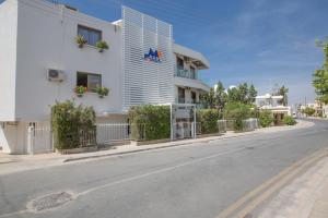 a white building on the side of a street at Ayia Napa Holiday Apartment So9 in Ayia Napa
