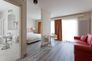 Postel nebo postele na pokoji v ubytování Hotel Delle Alpi
