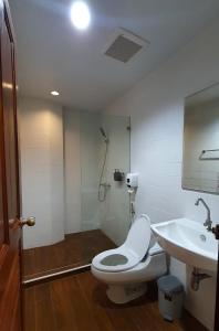 a bathroom with a toilet and a sink at Boon Street Hostel in Bangkok