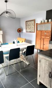 a dining room with a white table and chairs at Les Logis d Ussé in Rigny-Ussé