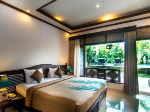 Postel nebo postele na pokoji v ubytování De Munut Balinese Resort