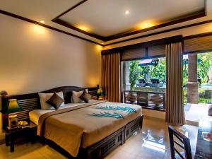 Postel nebo postele na pokoji v ubytování De Munut Balinese Resort