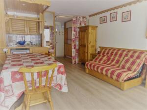 a bedroom with a bed and a table and a couch at Studio Tignes, 1 pièce, 5 personnes - FR-1-411-387 in Tignes