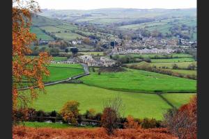 a green field with a town in the distance at 2 Bedroom apartment, Cononley near Skipton in Cononley