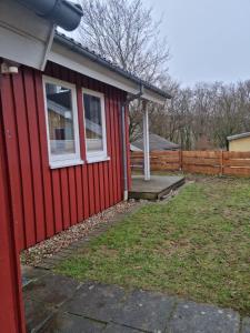 a red house with a white window and a porch at Ferienhaus Martina in Extertal