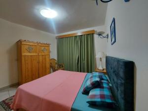 1 dormitorio con 1 cama y cortina verde en Happy day, en Sharm El Sheikh
