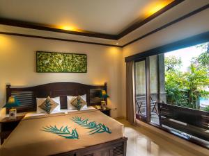 Postel nebo postele na pokoji v ubytování De Munut Balinese Resort
