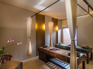 Postel nebo postele na pokoji v ubytování De Munut Balinese Resort