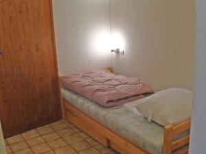 Kleines Zimmer mit einem Bett und einer Tür in der Unterkunft Appartement Samoëns, 2 pièces, 5 personnes - FR-1-629-38 in Samoëns