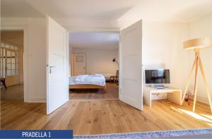 an open door to a bedroom with a bed and a television at Chalet Pradella by Arosa Holiday in Arosa