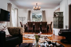 a living room with a dining room table and chairs at Hunter's Chalet, up to 10 p, terrace with amazing mountainview, 200 qm garden, BBQ&bikes&sunbeds for free in Golling an der Salzach