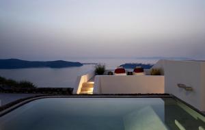 a house with a swimming pool with a view of the water at Atoles Retreat in Imerovigli