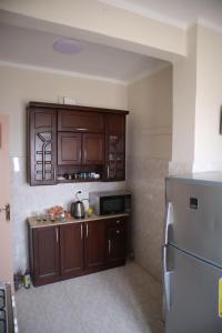 a kitchen with wooden cabinets and a refrigerator at Nile view apartment in Cairo