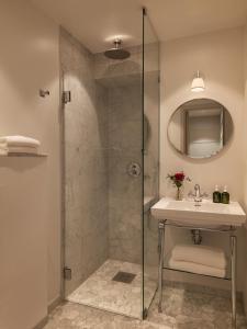a bathroom with a shower and a sink at Hotel Diplomat Stockholm in Stockholm