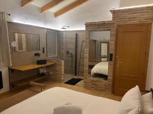 a bedroom with a bed and a bathroom with a shower at Villa parque natural in Murcia