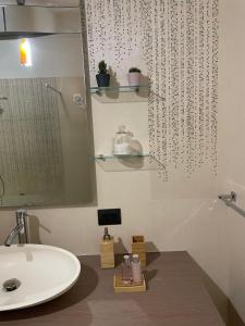 a bathroom with a sink and a mirror at B&B Archimede in Scanzano