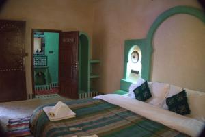 Postel nebo postele na pokoji v ubytování Maison Hassan Merzouga