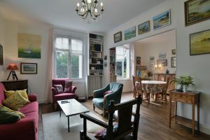 a living room with a couch and chairs and a table at Ile Celée - Maison de caractère proche plage in Dinard