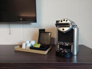 a coffee maker sitting on top of a table at Kza Jura Swiss in Courtedoux