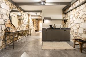 a kitchen with a stone wall and a counter at Charming Flat near Hadrians Gate in Antalya