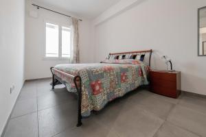 a bedroom with a bed with a quilt on it at Realkasa Fiera District Flat in Bologna