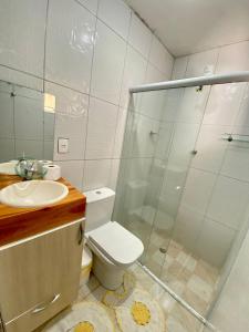 a bathroom with a shower and a toilet and a sink at Chácara das Suculentas in Mairiporã