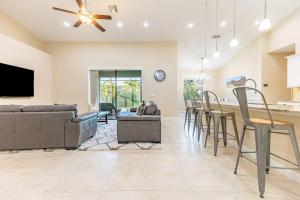 a kitchen and living room with a couch and a table at Villa -natalia in Cape Coral