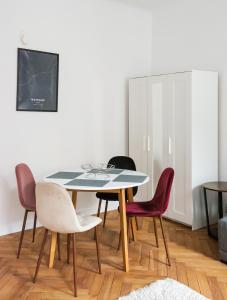 a dining room with a table and four chairs at Chmielna Warsaw City Centre Apartment in Warsaw