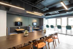 a conference room with a large wooden table and chairs at Silk Mill Edinburgh in Edinburgh