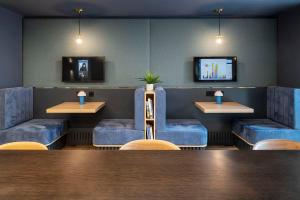 a dining room with blue chairs and a table at Silk Mill Edinburgh in Edinburgh +30 photos