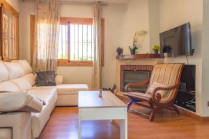 a living room with a couch and a fireplace at Adosado al lado del Torreón in Benicàssim