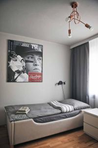 a bedroom with a bed with a poster on the wall at Mieszkanie nad Maltą in Poznań