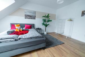 a bedroom with a bed with a stuffed animal on it at FullHouse - Magdeburg - L10 Apartments in Magdeburg