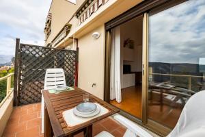 ein Balkon mit Tisch und Stühlen auf einem Balkon in der Unterkunft CASA MANU FINALE LIGURE in Finale Ligure
