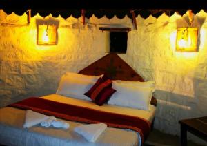 a bedroom with a bed with towels on it at AnanyaVaas in Dedha