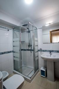 a bathroom with a shower and a toilet and a sink at Apartamentos AMAT - Only Adult - Playa El Bajondillo in Torremolinos