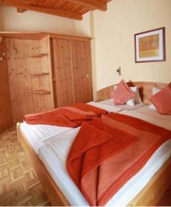 a bedroom with two beds with red blankets on them at Haus Schuster in Kirchbach