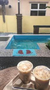 a table with two cups of coffee on top of it at Homestay Rumah Cikgu 3bilik tidur in Jitra