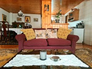 a living room with a couch and a table at Casa RAI in Predeal