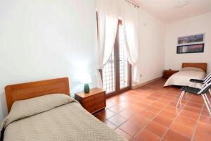 a bedroom with two beds and a tiled floor at Villa Montedoro Luxury in Noci +38 photos
