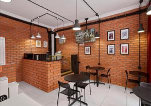 a restaurant with tables and chairs in a brick wall at HELLO INN budget hotel in Astana