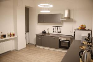 a kitchen with a sink and a stove at Ferienwohnung Blaßdörfer - Traumhafte Altbauwohnung mit Self-Checkin und 93 qm2 in Bad Kissingen