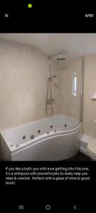 a picture of a bath tub in a bathroom at The Barn in Saltash +88 photos