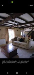 a living room with a couch and a coffee table at The Barn in Saltash