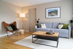 a living room with a couch and a table at Sonnige Panorama Aussicht bei Davos Lenzerheide in Schmitten