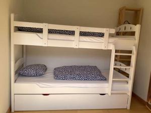 a white bunk bed with two pillows in a room at BnB Försterlodge in Schwarzsee