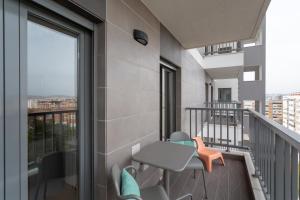 an apartment balcony with a table and chairs and a window at BeGuest Vasco da Gama Apartment in Lisbon