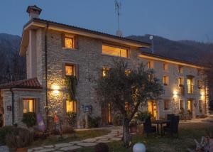 a large stone house with lights on it at Agriturismo Casaborgomarche in Valdobbiadene